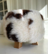 brown and white sheepskin stool