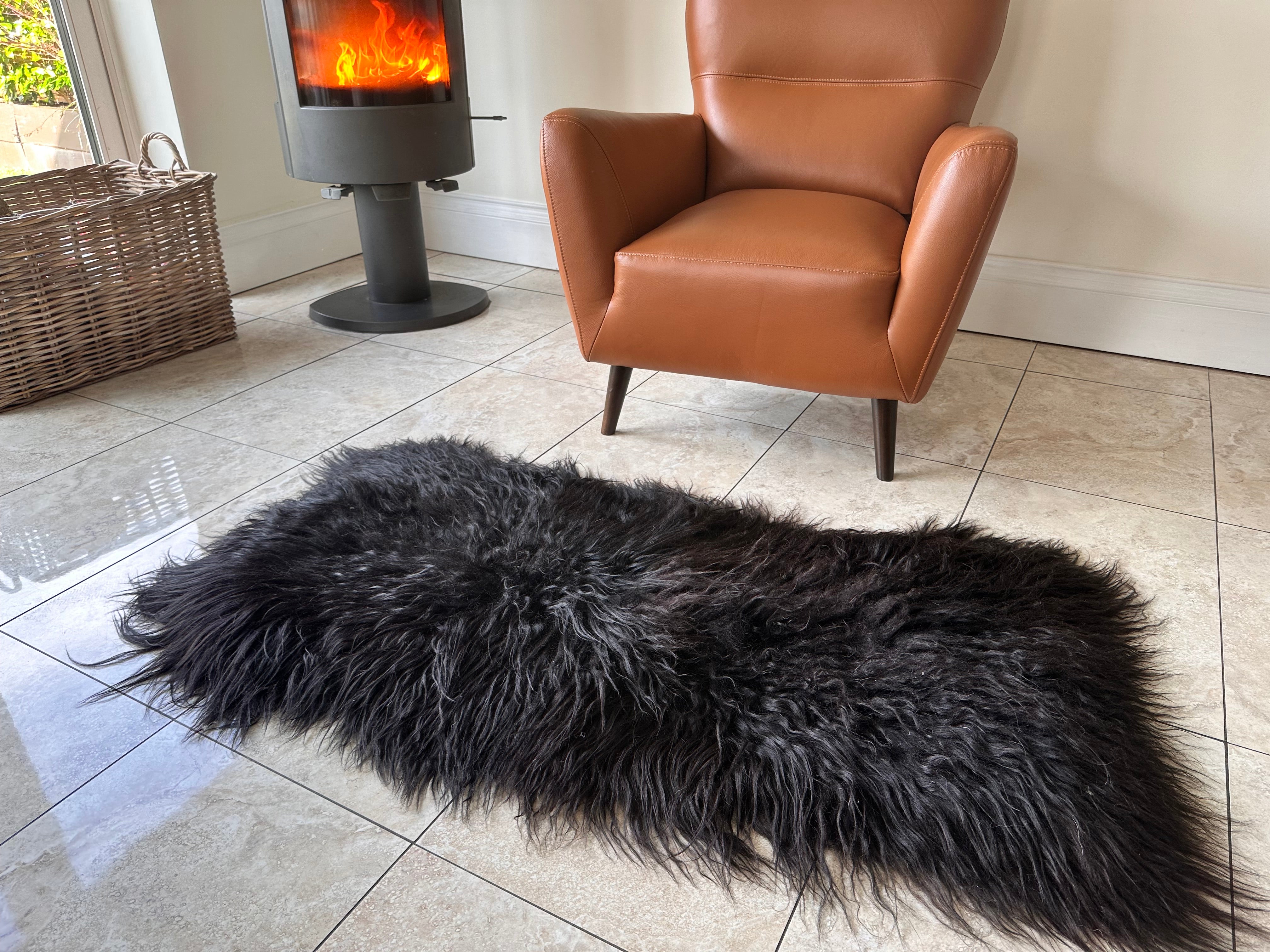 black rectangular sheepskin rug