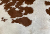 brown and cream cowhide  rug