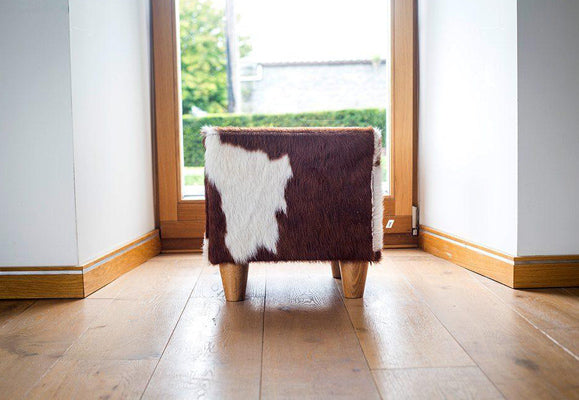 red and white cowhide footstool