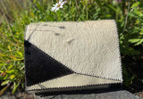 cowhide and leather clutch bag