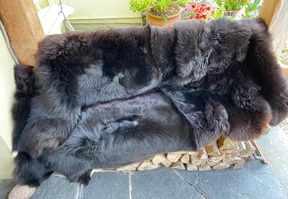 large black quad sheepskin rug