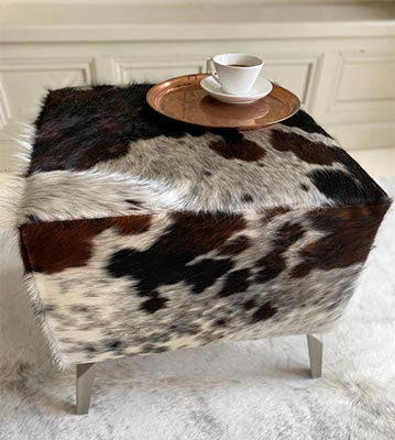 red and black cowhide footstool