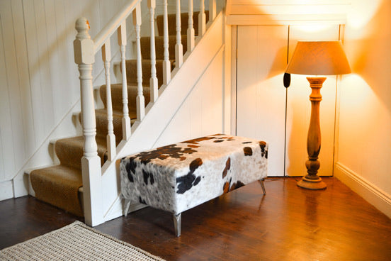 white and red cowhide ottoman